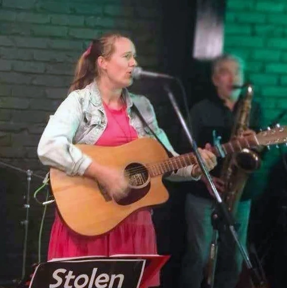 Bridget from Stolen Jukebox, playing guitar and singing