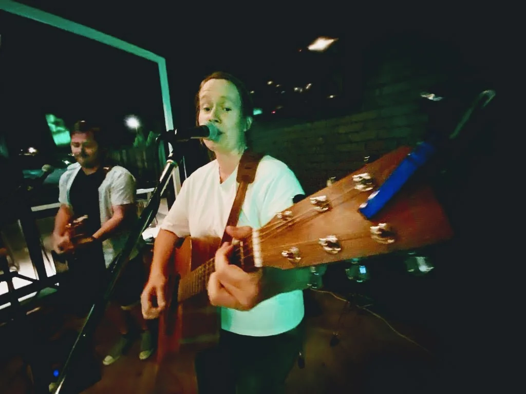 Stolen Jukebox close up of bridget playing the guitar during a song